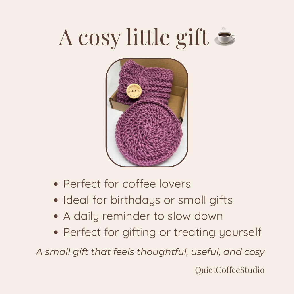 Crocheted purple coffee cozy in a box with text describing its use and benefits.