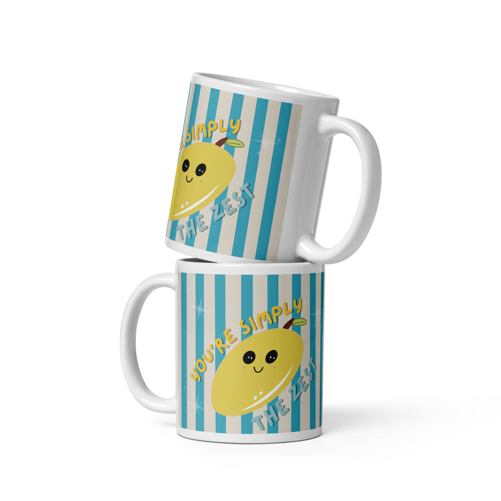 Cute white ceramic mug with blue vertical stripes and a smiling yellow lemon illustration featuring the phrase “You’re Simply The Zest”. Perfect for summer coffee, tea and cosy desk setups.